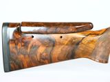 a close up of a rifle with a wooden handle on a white background