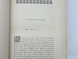 an open book sitting on top of a table next to a white table