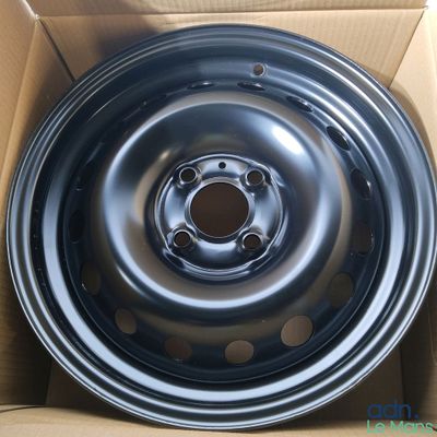 a close up of a black rim in a cardboard box