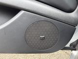 a close up of a car door with a speaker in it