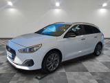 the white car is parked on a checkered floor in the garage