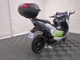 a motor scooter with a helmet on the back of it