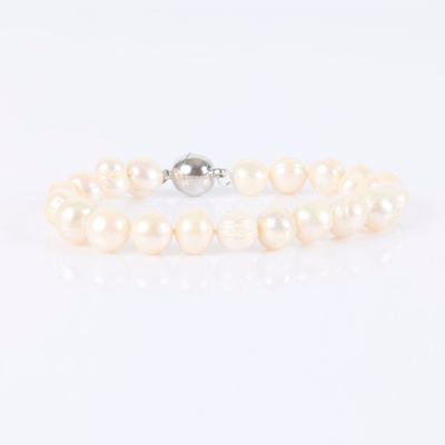 a white pearl bracelet with a silver clasp on a white background