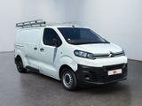 the white van is parked in a room with a white wall
