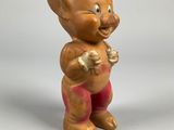 a small figurine of a troll with a toothbrush in his hand