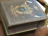 an old book sitting on a chair in a room