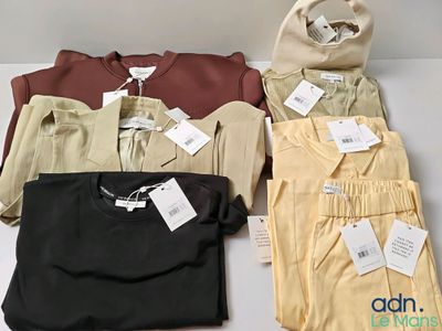 three shirts and a bag are sitting on a table