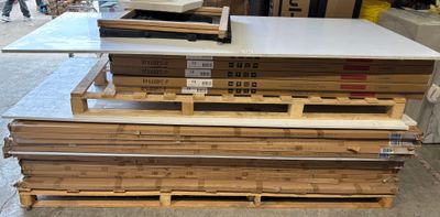several stacks of wooden pallets stacked on top of each other in a warehouse