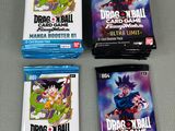 three packs of dragon ball trading cards sitting on top of a table