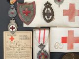 an image of a collection of medals and a certificate on a table