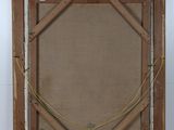 an old picture frame with a rope and a piece of wood