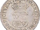 a silver coin with a crown on top of it