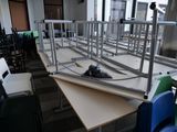 tables and chairs in a room with a lot of desks and chairs