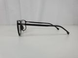 a pair of black glasses sitting on top of a white table