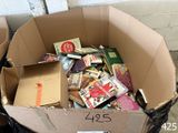 a cardboard box full of books sitting on the floor