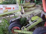 a close up of a tractor with a plow attached to it