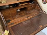 a wooden desk with a drawer underneath it in a room