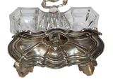 a silver box with a crystal handle on a white background