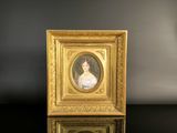 a gold frame with a picture of a woman in a white dress