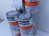 several cans of paint are stacked on top of each other