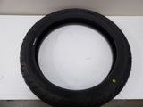 a tire on a white surface with a black rim