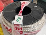a spool of rope and a measuring tape on a table