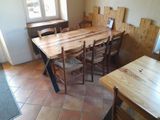 a wooden table and chairs in a room with tile flooring