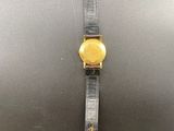 a close up of a watch on a black surface