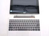 a laptop and a tablet on a white table