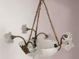 a chandelier hanging from the ceiling with flowers on it
