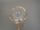 a glass vase with a gold rim sitting on a table