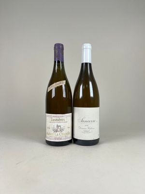 two bottles of wine sitting next to each other on a table