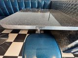 a black and white checkered floor and a blue booth