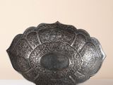 an image of a metal bowl sitting on top of a white table