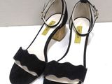 a close up of a pair of black shoes on a white surface