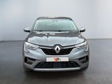 the front view of a grey car in a showroom
