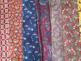 several different colored ties are lined up on a table