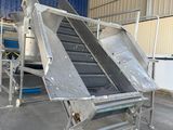 an image of a conveyor belt in a warehouse with a conveyor belt in the foreground