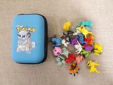 a blue case with a bunch of pokemon figurines in it