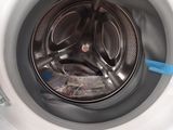 a close up of a washing machine with the door open