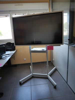 a flat screen tv sitting on a stand in the corner of a room