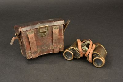 two old binoculars sitting next to each other on a table