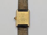a close up of a watch on a white surface