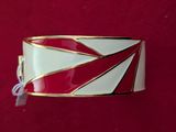 a close up of a red and white bracelet on a red surface
