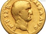 a close up of a gold coin with a man ' s face on it