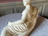 a statue of a woman that is sitting on a table