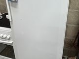 a white refrigerator sitting in the corner of a room