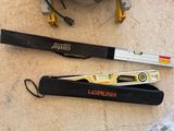two tools that are laying on the floor next to each other