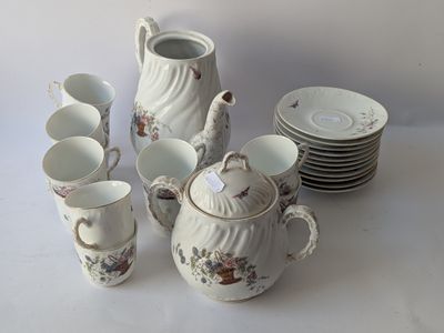 a white table with a lot of cups and saucers