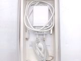 a white box containing a charger and a cable
